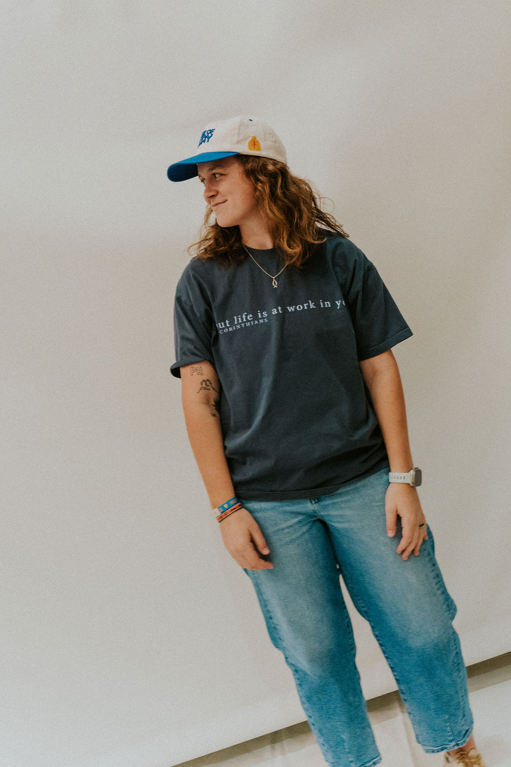 Gabby Gonzales-Heck in a Made of Clay cap and a 2 Corinthians t-shirt